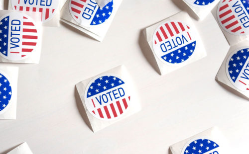”I voted“ stickers on a white table.