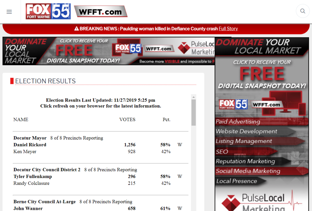 A website showing election results surrounded by large advertising blocks.
