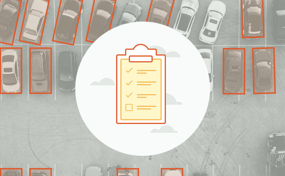 Illustration of a clipboard overtop of labeled cars in a parking lot.