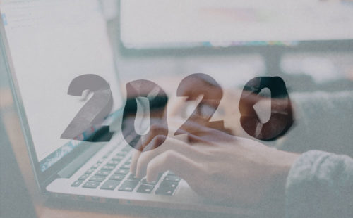 Crumpled numbers spelling "2020" overlaid with an image of a person's hands typing on a laptop.