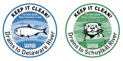 Two circular graphics stating "keep it clean!" and then information to report dumping or clocks. One of the graphics has a fish icon and says "Drains to Delaware River" and the other has an otter icon and says "Drains to Schuylkill River". These are stormdrain markings designed by the Philadelphia Water Department. 